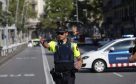 A policeman stands as he blocks the traffic after a van plowed into the crowd, injuring several people in Barcelona, Spain. (Photo by Albert Llop/Anadolu Agency/Getty Images)