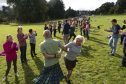 People taking part in the world record for the longest Strip the Willow at the National Trust for Scotland property Castle Fraser in Aberdeenshire