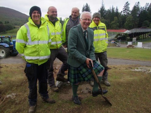 President of Braemar Royal Highland Society David Geddes, helped staff from building contractor Gordon Mitchell's start with the ground clearing in the Games Park
