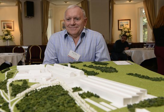 Smelter Director, Brian King with the 3D model of the proposed new factory.