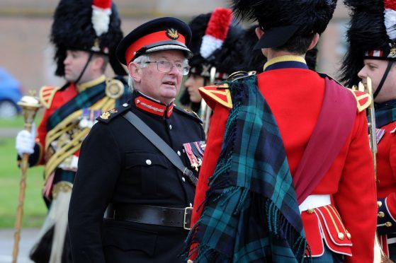 Lieutenant Colonel Grenville Shaw Johnston handing out medals.