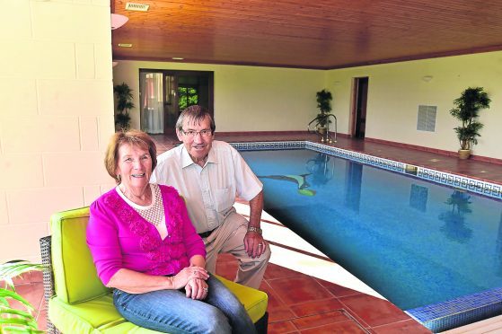 James and Marie Sutherland by the indoor pool