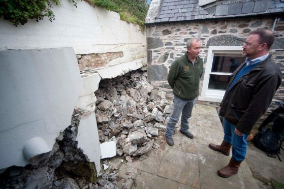 David Duguid inspects damage at Sandend following the landslip.