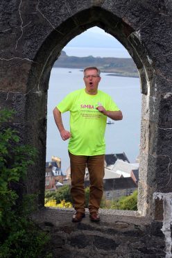 Brendan O'Hara MP Argyll does his bit of the proclaimers  "I would walk 500 miles .... for Team Simba in the iconic setting of McCaigs Tower Oban. Simba have asked celebrities members of parliament to take part in a video which will be edited and published to highlight the work of the charity picture kevin mcglynn