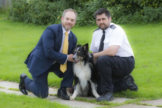 Stuart Moore and Kenny Sharpe (Assistant Manager of SSPCA Edinburgh Centre) with Fudge, who has been in the care of the SSPCA for 294 days.