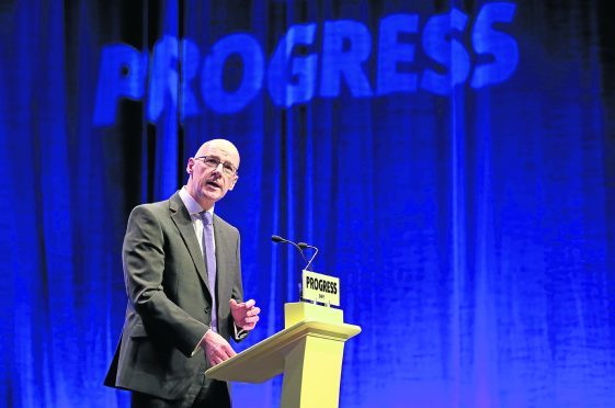 Deputy First Minister of Scotland John Swinney delivers the opening address to delegates at the  Scottish National Party (SNP) conference at the SEC Centre in Glasgow.