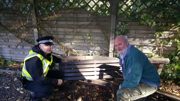 Constable Andrew Shepherd with community volunteer Harry Hansen with one of the damaged benches.