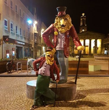 Johnny Kessack poses with the real Dandy Lion in Elgin