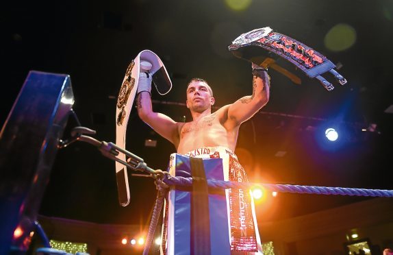 Lee McAllister with both PBC belts that he won.