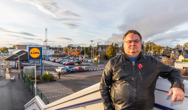 Councillor Graham Leadbitter overlooking the car park at Elgin's railway station