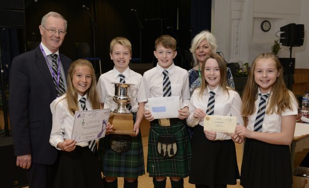 Councillor Allan Hendeson and Morag Anna Macleod of the Highland Council present the award to Dingwall singers (left - right)  Mhairi MacKenzie, Ruaraidh Drennan, Finlay MacLennan, Andrea MacDonald and Isabelle Rose.