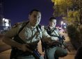 Police officers advise people to take cover near the scene of the shooting near the Mandalay Bay resort and casino on the Las Vegas Strip