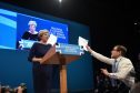 Comedian Simon Brodkin, also known as Lee Nelson confronts Prime Minister Theresa May during her keynote speech at the Conservative Party Conference at the Manchester Central Convention Complex in Manchester.