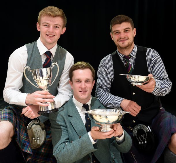 Three winners in the adult piping classes, (L-R) Sandy Cameron of Roy Bridge with the John T. MacRae Cup for the March, Strathspey and Reel; Charles Macdonald of Inverness with the James R. Johnston Memorial Trophy for Piobaireachd and Angus MacColl of Benderloch with the Argyllshire Gathering Quaich for the Hornpipe and Jig competition in Lochaber High School.