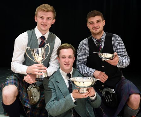 Three winners in the adult piping classes, (L-R) Sandy Cameron of Roy Bridge with the John T. MacRae Cup for the March, Strathspey and Reel; Charles Macdonald of Inverness with the James R. Johnston Memorial Trophy for Piobaireachd and Angus MacColl of Benderloch with the Argyllshire Gathering Quaich for the Hornpipe and Jig competition in Lochaber High School.