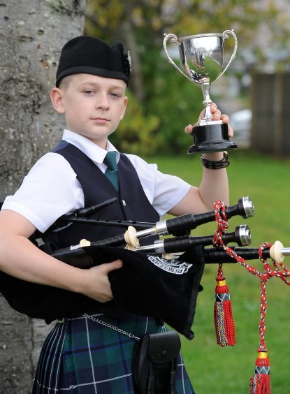 Curran Stainthorpe of Dumfries with the Roderick Ross , Ferintosh Memorial Trophy for playing a march in the Junior piping competitions.