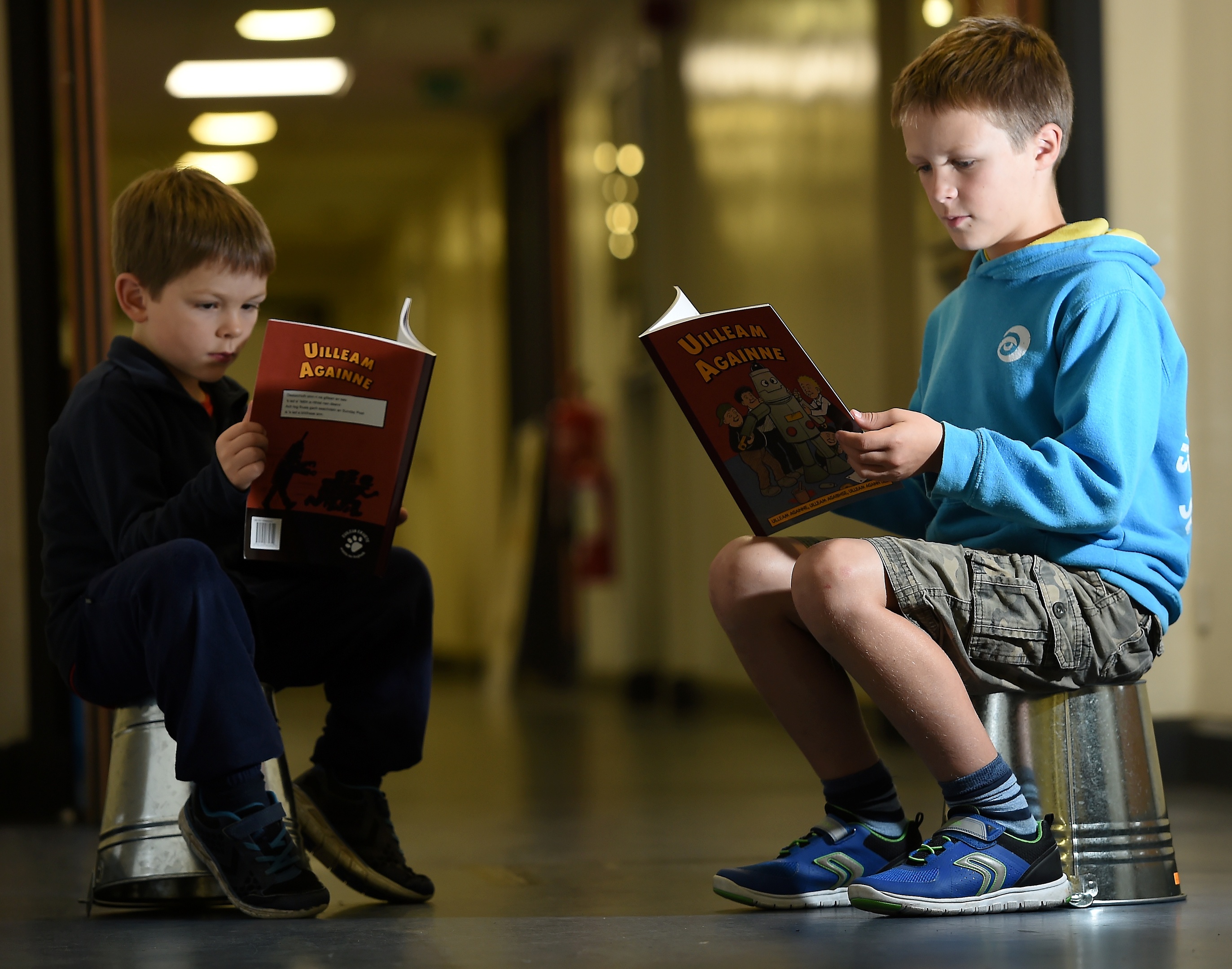 Alasdair Stiubhart enjoys a newly released Oor Willie book which has been translated in to Gaelice and was launched at the Mod. Also in the photograph is younger brother Seumas. Picture by Sandy McCook.