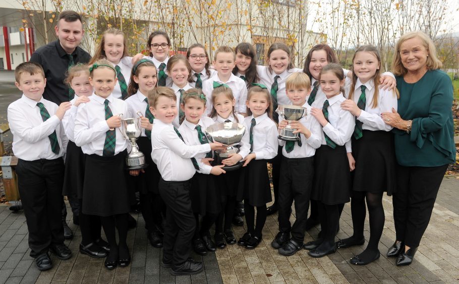 Rionnagan Rois from Ross-shire with their three trophies for Choral Singing.