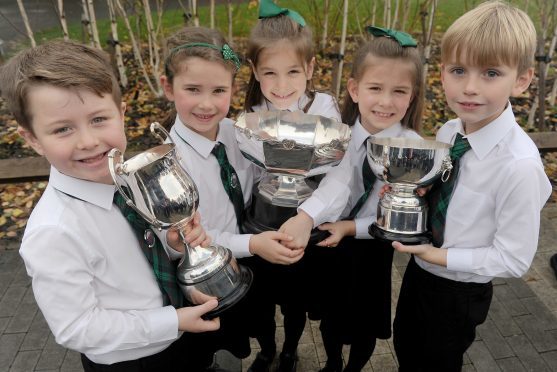 Rionnagan Rois from Ross-shire with their three trophies for Choral Singing. (L-R)Five  members of the choir  Alisdair Gordon, Morag Ross, Alex Goodall, Sophie Stewart and Ruairidh Somerville with the trophies won by the entire choir.