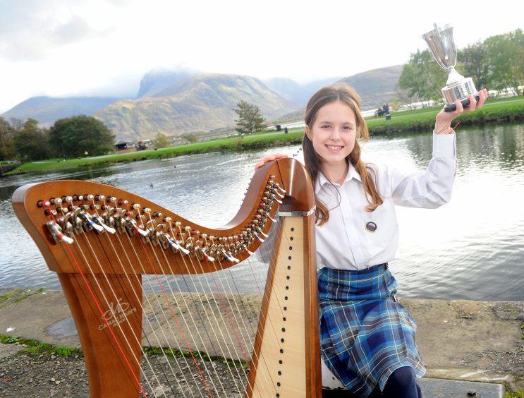 Anna Pearson of Parkside Primary School, Edinburgh with the Florence Wilson Trophy for Clarsach.
