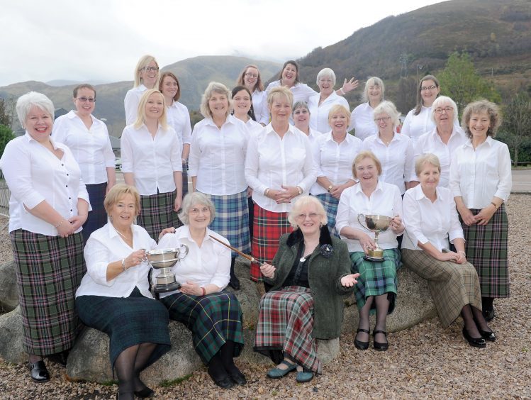 Mull Gaelic Choir with their conductress Elizabeth Jack with their haul of trophies, The Grampian Television Trophy,The Rod MacKenzie Memorial Baton and The Angus MacTavish Memorial Trophy.