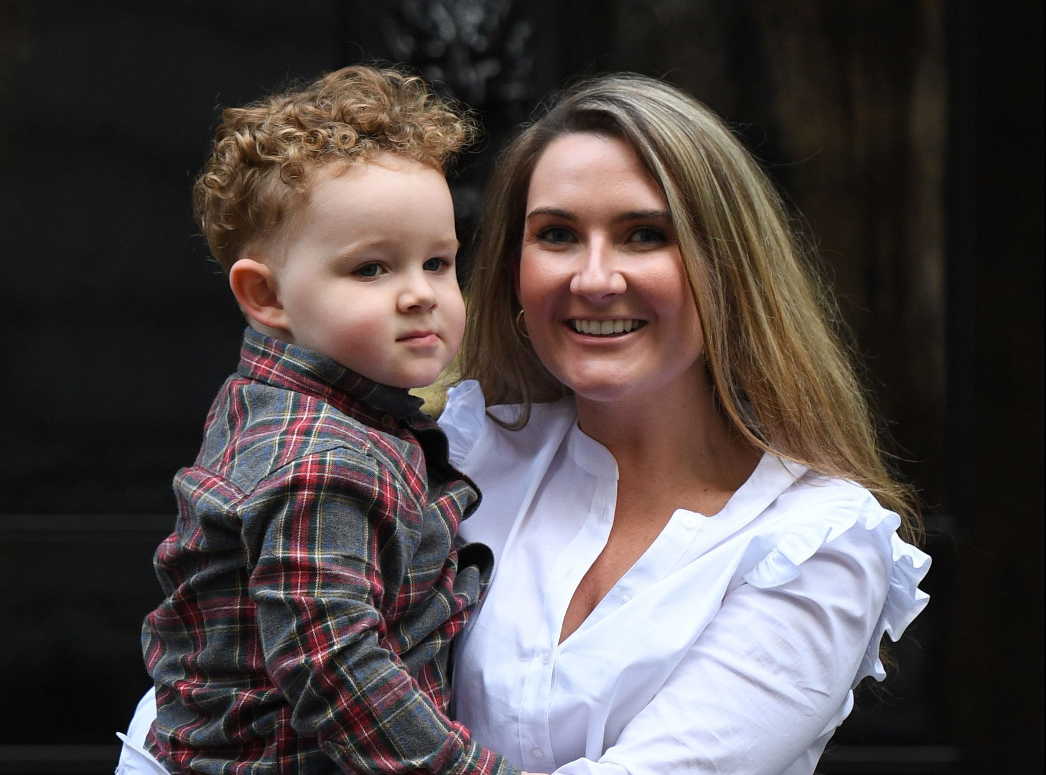 Yvonne MacHugh, fiance of Billy Irving and her two year old son, William deliver a petition to 10 Downing Street in London