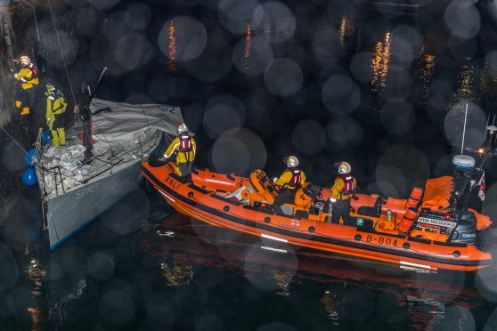 Yacht Spirit being manouvered into bertth by the Lifeboat Crew and the Sea Helper at Macduff Harbour.