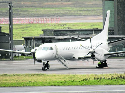 Pis show the wheels of the Saab 2000 being inspected at Stornoway Airport