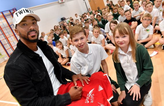 Footballer Shay Logan with Kai Muirhead and Sophie Seston (right).  
Pictures by Kami Thomson.