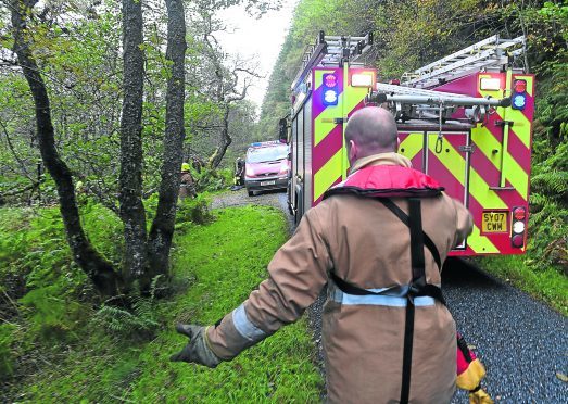 Emergency services deal with the fisherman who became trapped by rising water on the River Glass in Inverness-shire yesterday.  Pic by Sandy McCook.