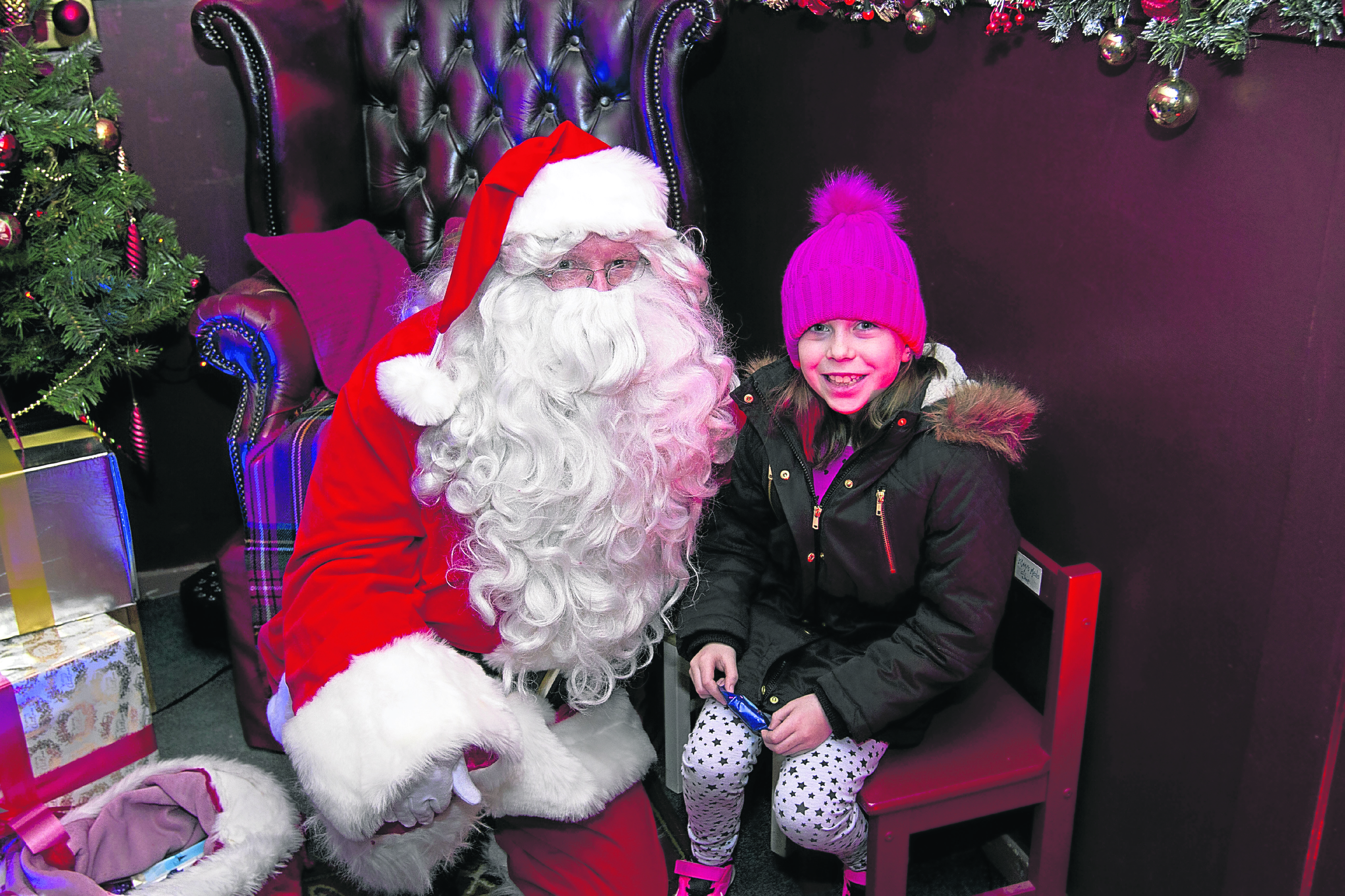 Young Jennifer Campbell Rockfield delivers her gift to santa for homeless and needy children.