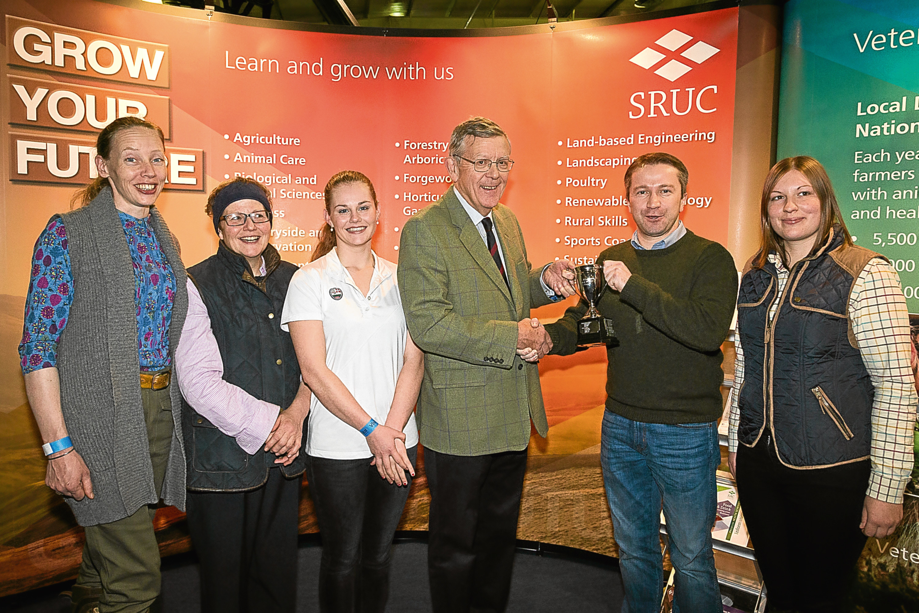 John Rhind, a Trustee of Mains of Loirston Trust, presents the 2017 Winter Wheat Challenge trophy to SRUC students, (left to right): Joanne Breese, Helen Parker, Emma Parvin, Timur Kharisov (team captain) and Heather Duff at AgriScot. The students are based at SRUC’s Aberdeen campus.