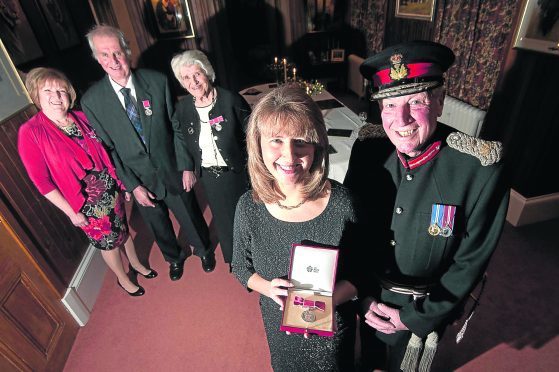 The Lord-Lieutenant of Aberdeenshire James Ingleby presents four recipients of the British Empire Medal at Invermarkie, Glass near Huntly.

In photo from the left ,Mari McGowan, Alistair Cassie, Christine Sutherland, Eileen Buchan and The Lord-Lieutenant of Aberdeenshire James Ingleby