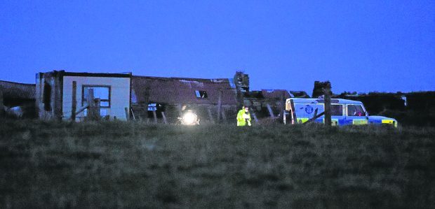 Police and SSPCA officials at the scene of the fatal fire in a portable cabin at Lyth in Caithness. Pic by Sandy McCook.