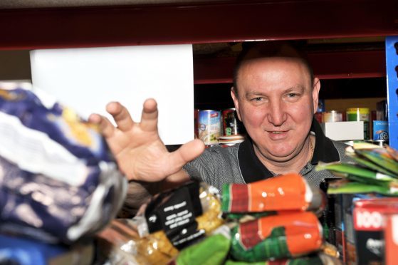 Gilbert Grieve filling food parcels at Moray Foodbank.