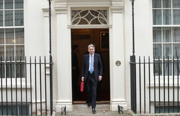 Chancellor Philip Hammond holding his red ministerial box outside 11 Downing Street, London, before heading to the House of Commons to deliver his Budget.