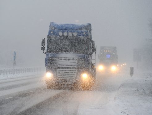 A heavy shower affects drivers on the A9 dual carraigeway at Bogbain, Inverness. Pic by Sandy McCook.