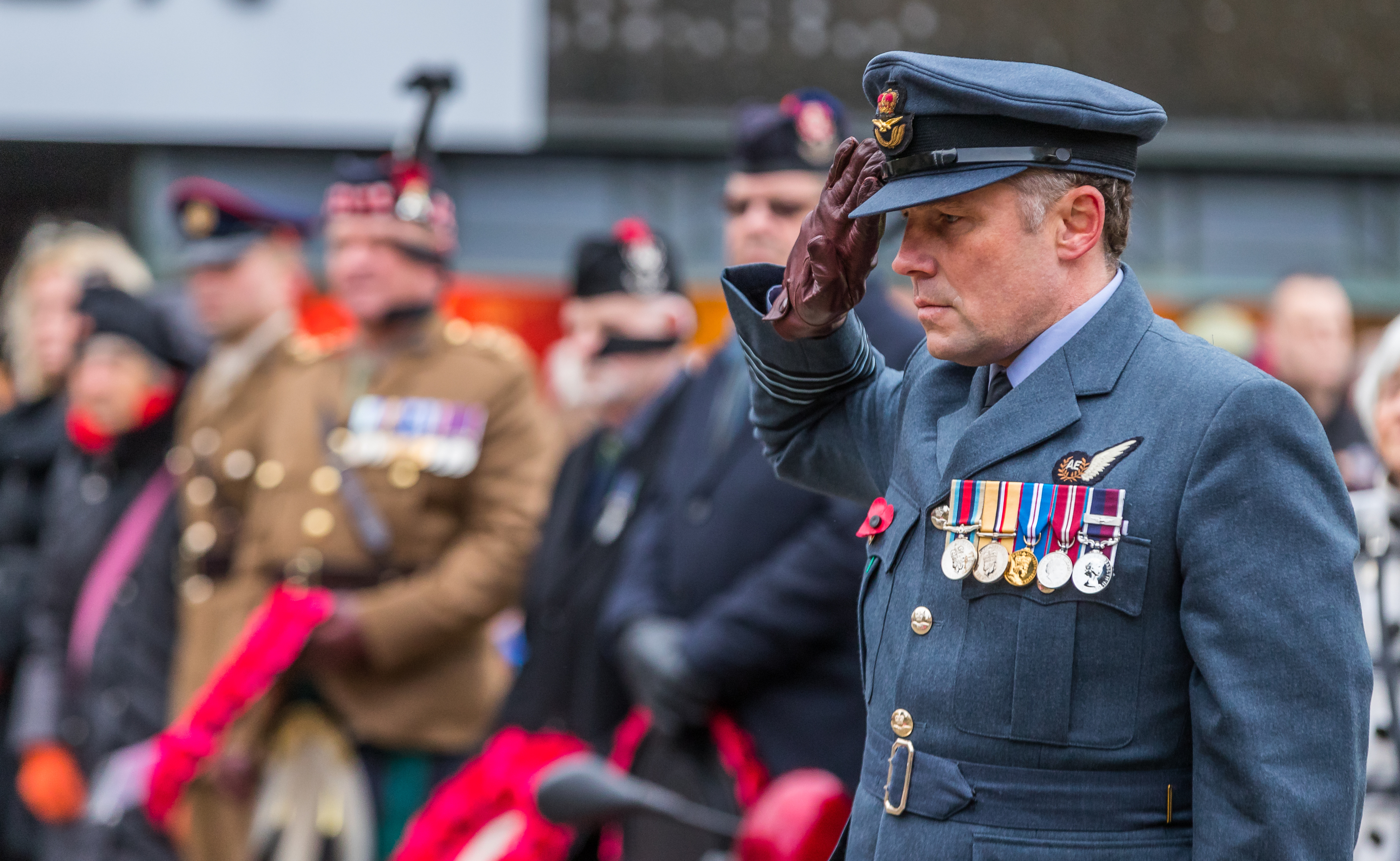 Wing Cmdr David Allen salutes at the Elgin remembrance service.