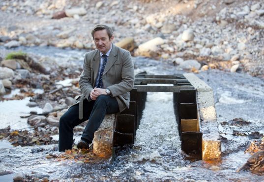 Roger Knight, director of the Spey Fishery Board, in the Fochabers Burn.