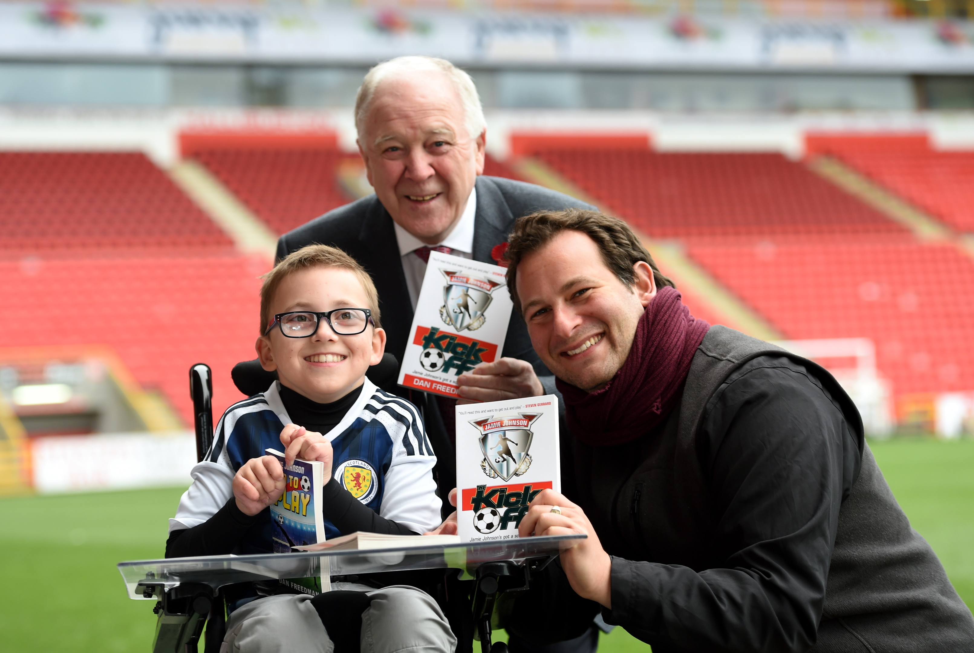 Pictured are from left, Former Scotland manager Craig Brown, Finlay Sangster, 12 and author Dan Freedman at Pittodrie Stadium,