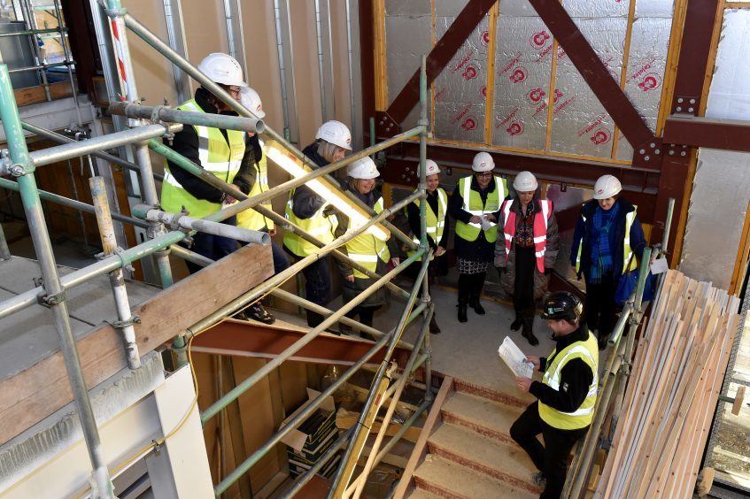 NHS health workers are shown round the site by assistant site manager Michael Cleavin.