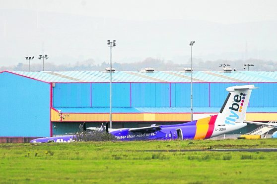 The Flybe BE331 plane on the tarmac after it landed with no nose gear at Belfast International Airport.