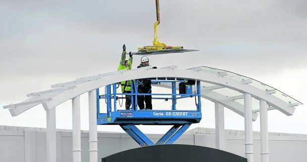 Work continued yesterday to remove glass panels from canopies above the walkway of the Inverness Business and Retail Park. Pic by Sandy McCook