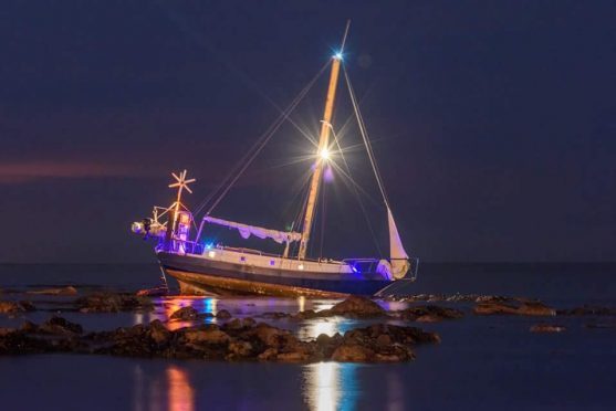 The boat is stranded in Stonehaven Bay