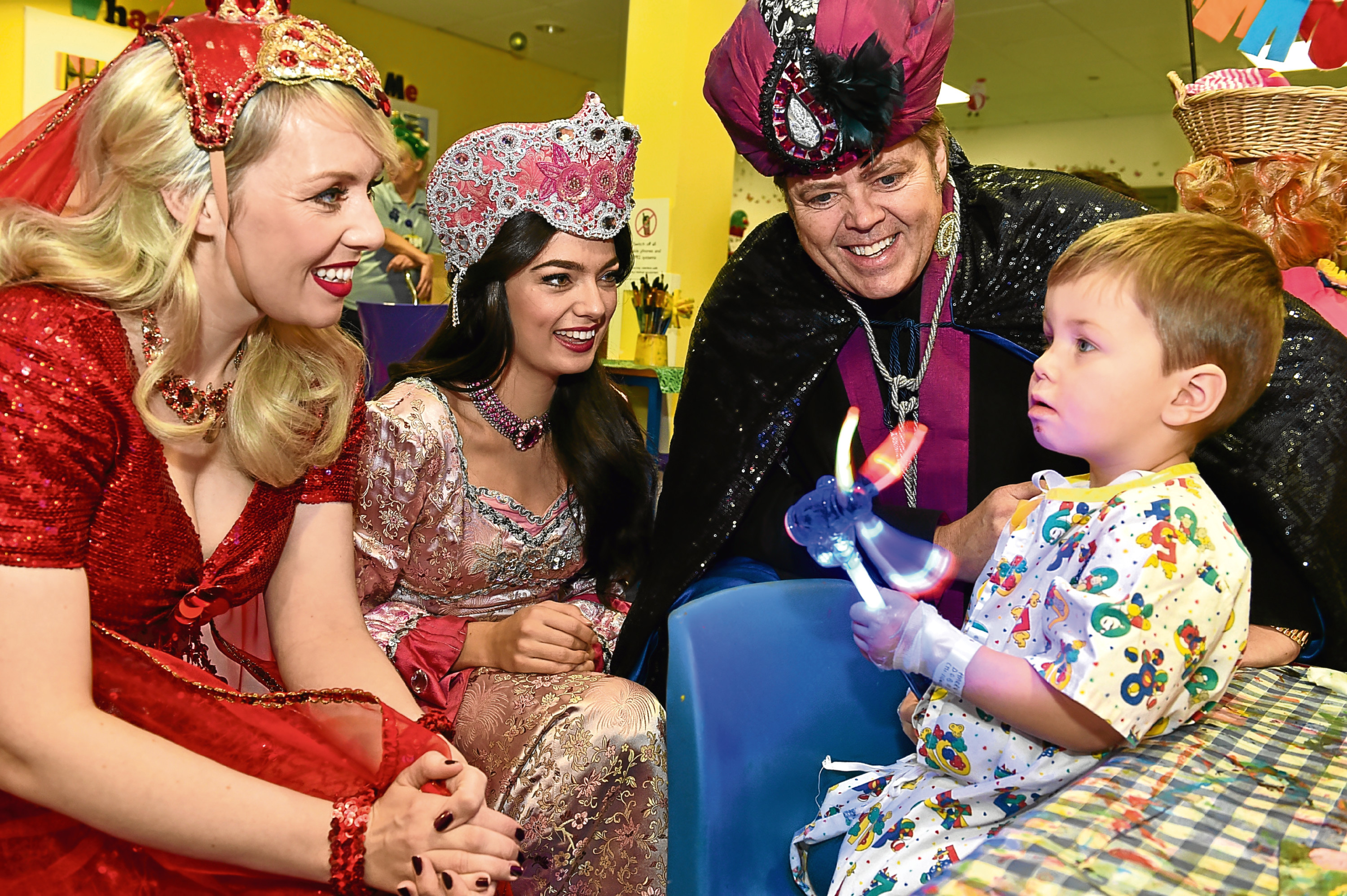 The cast (from left) Nicola Jane Meehan (Scheherazade), Lisa-Anne Wood (Princess Jasmine), Jimmy Osmond (Abanazar) with two year old Harry Westwood from Banchory. Pictures by Colin Rennie.