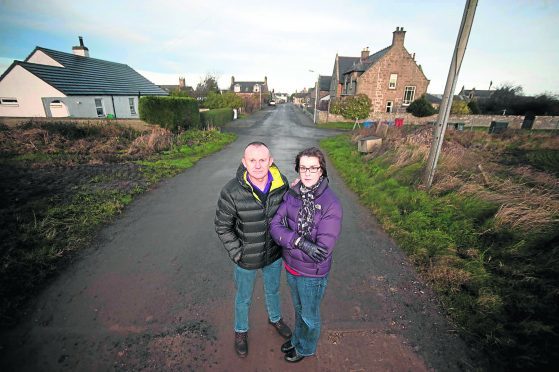 Residents April Charlesworth and her husband Jeff Povoas on one of the streets affected by flooding.