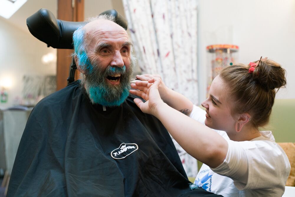 Michael Laycock being shaved by carer Toni Cameron.