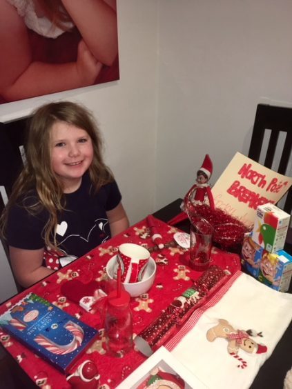 Ayiana Stewart (age 8) with her elf Sparkle who made her a North Pole breakfast