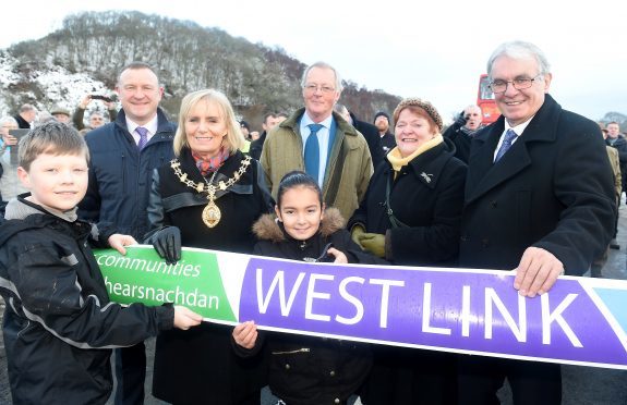 Provost Helen Carmichael of Inverenss assisted by pupils Roddy McLennan of Kinmylies Primary School and Kelsey Campbell of Holm Primary School perform the official cutting of the ribbon. Picture by Sandy McCook.