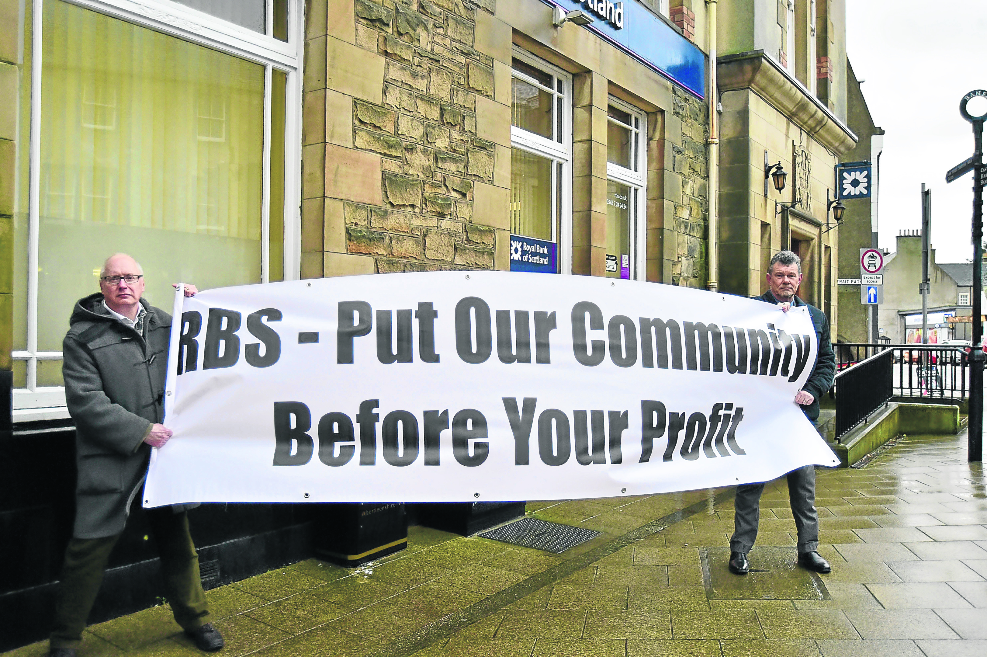 Councillors Glen Reynolds and Ross Cassie demonstrate outside the RBS in Banff